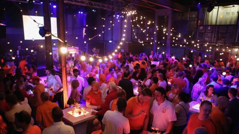 Event met veel mensen tijdens een borrel in oranje kleding