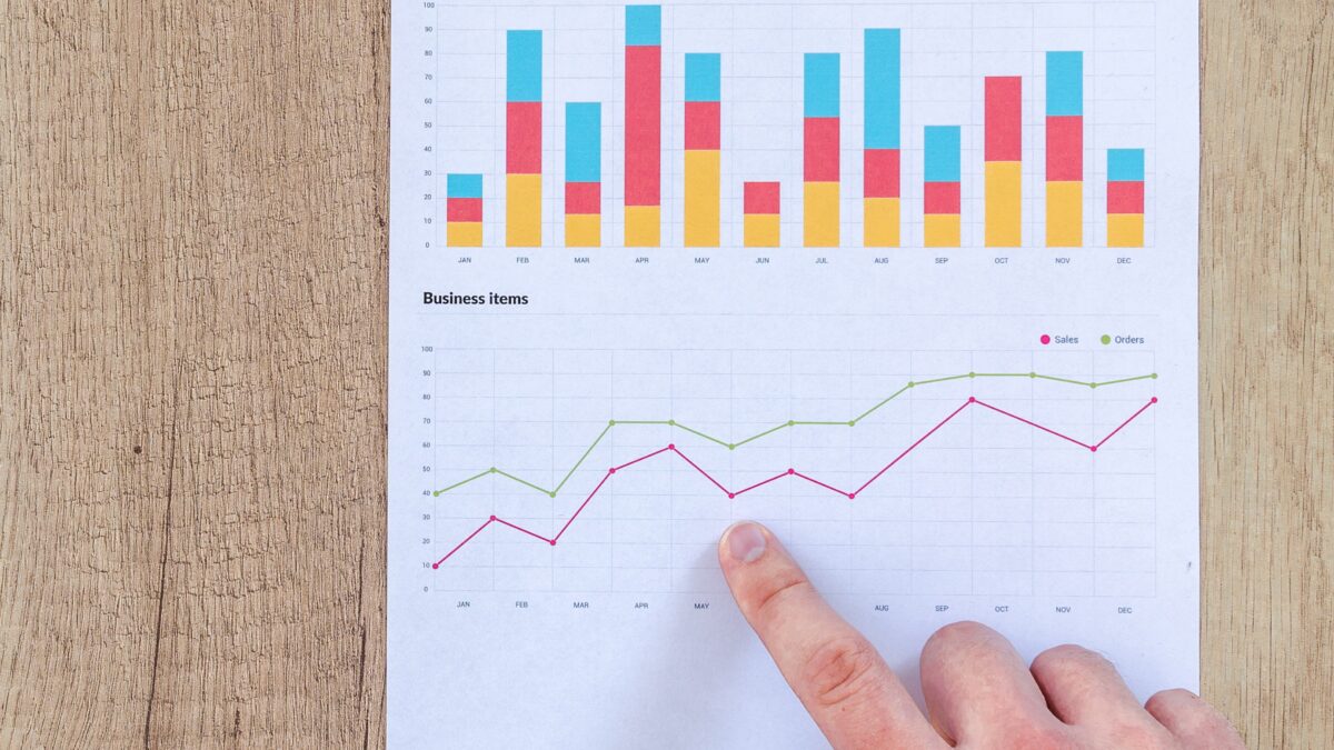 Man showing business graph on wood table